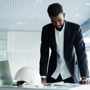 successful-businessman-handsome-young-african-man-e-standing-in-creative-office